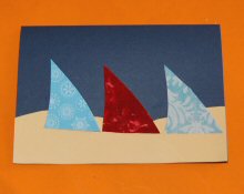 Stick the cloak shapes onto the card