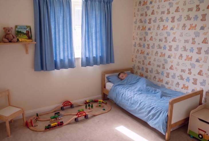 Child in bed while it is still light outside